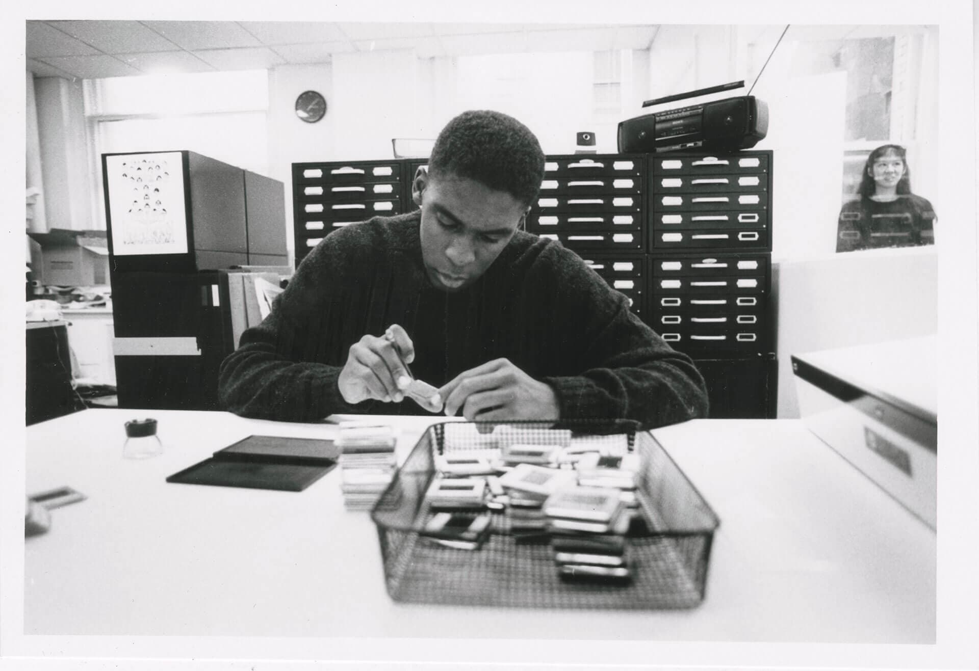 Researcher Examining Slides in Parsons School of Design Library