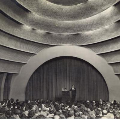 Black and white photograph of an auditorium stage.