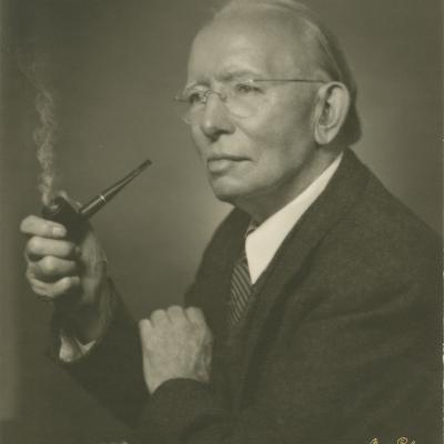 Black and white photo of man smoking a pipe