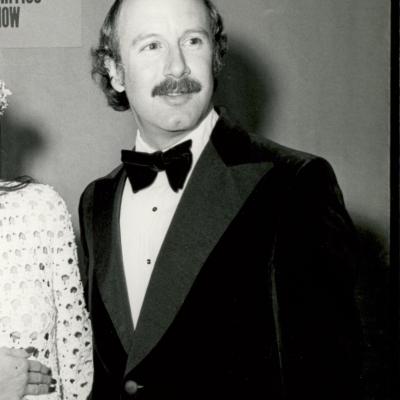 Black and white photo of a man in a tuxedo.