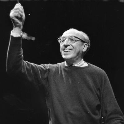 Black and white photo of a man conducting music.